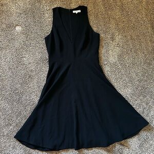 Black, large, mid-length dress.